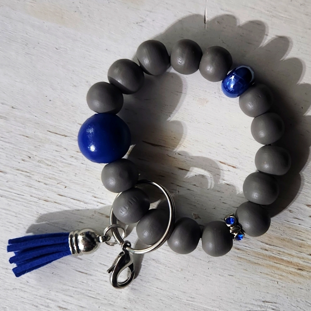 Keychain bracelet with wooden beads and tassel. Never Used